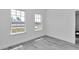 Bright bedroom featuring new hardwood floors and two windows at 13430 Sw 88Th Ter, Ocala, FL 34473