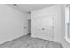 Bedroom showcasing new hardwood floors, a window, and a closet with doors at 13430 Sw 88Th Ter, Ocala, FL 34473