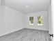 Bright bedroom with wood floors, neutral paint and large window allowing for lots of natural light at 13430 Sw 88Th Ter, Ocala, FL 34473