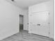 Spacious bedroom features hardwood style flooring, neutral walls, a walk in closet and attached bathroom at 13430 Sw 88Th Ter, Ocala, FL 34473