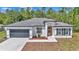 Charming single-story home featuring a modern design, two car garage, and fresh landscaping at 13430 Sw 88Th Ter, Ocala, FL 34473