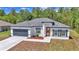 Lovely single-story home showcasing a modern design, a two-car garage, and fresh landscaping at 13430 Sw 88Th Ter, Ocala, FL 34473