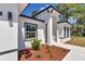 Close-up view of the front door showcasing clean architecture and low maintenance landscaping at 13430 Sw 88Th Ter, Ocala, FL 34473