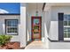 Close-up view of the front door showcasing clean architecture and low maintenance landscaping at 13430 Sw 88Th Ter, Ocala, FL 34473