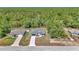 Aerial front view of a single Gathering home with an attached garage and long driveway and wooded backdrop at 13430 Sw 88Th Ter, Ocala, FL 34473