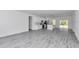 Spacious open-concept living area with sleek gray flooring and an eat in kitchen at 13430 Sw 88Th Ter, Ocala, FL 34473