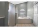 Bathroom with a shower, a garden tub under a window, and ceramic tile flooring at 135 Andrews Rd, Sanford, FL 32773