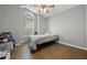 Bedroom with wood-look floors, a vaulted ceiling, and a large window at 135 Andrews Rd, Sanford, FL 32773