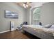Bright bedroom with dark wood floor, ceiling fan, large window, and flat screen television at 135 Andrews Rd, Sanford, FL 32773