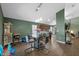 Bright dining area with modern glass table, stylish chairs, and wood laminate floors at 135 Andrews Rd, Sanford, FL 32773