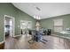 Bright dining area with modern glass table, stylish chairs, and wood laminate floors at 135 Andrews Rd, Sanford, FL 32773