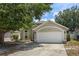 Charming one-story home featuring an attached two car garage and mature landscaping at 135 Andrews Rd, Sanford, FL 32773