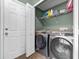 Convenient laundry room with modern washer and dryer units and storage shelving at 135 Andrews Rd, Sanford, FL 32773