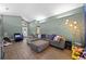 Comfortable living room with gray sectional, wood floors, and lots of natural light at 135 Andrews Rd, Sanford, FL 32773
