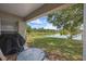 Covered patio offers stunning lake views, ideal for relaxation and outdoor dining with table and chairs at 135 Andrews Rd, Sanford, FL 32773