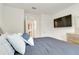 Bright bedroom with large TV, featuring neutral walls and plush bedding for comfort at 1535 Barberry Dr, Kissimmee, FL 34744