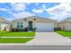 Charming single-story home with a well-maintained lawn and a two-car garage, creating great curb appeal at 1535 Barberry Dr, Kissimmee, FL 34744