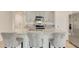 Stylish kitchen featuring granite countertops, stainless steel appliances, gray cabinets, and a breakfast bar at 1535 Barberry Dr, Kissimmee, FL 34744