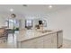 Open-concept kitchen island with a double sink, granite countertop, and seamless connection to the living area at 1535 Barberry Dr, Kissimmee, FL 34744