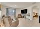 Comfortable living room with tile flooring, large screen tv, and natural light from the window at 1535 Barberry Dr, Kissimmee, FL 34744