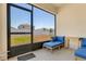 Relaxing screened patio with comfortable blue seating, perfect for enjoying the outdoors at 1535 Barberry Dr, Kissimmee, FL 34744