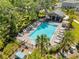 Aerial view of a refreshing community pool with lounge chairs and lush landscaping at 1535 Barberry Dr, Kissimmee, FL 34744