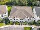 Birds eye view of townhome complex with parking, lush lawn and manicured landscaping at 17230 Blessing Dr, Clermont, FL 34714