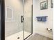 Clean, modern bathroom featuring a frameless glass shower with matte black hardware, tile, and towel rack at 17230 Blessing Dr, Clermont, FL 34714
