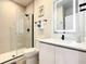 Modern bathroom featuring a glass shower, black fixtures, vanity with undermount sink, and tile flooring at 17230 Blessing Dr, Clermont, FL 34714