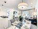 Elegant dining area with a modern chandelier, comfortable seating, and view to living area at 17230 Blessing Dr, Clermont, FL 34714