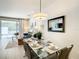 Comfortable dining room adjacent to the living room and views of the screened lanai and pool at 17230 Blessing Dr, Clermont, FL 34714