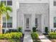 Close up view of townhome entrances featuring stone accents and manicured landscaping at 17230 Blessing Dr, Clermont, FL 34714