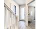 Bright hallway with modern decor, leading to a bedroom with a dressing area and gray carpet at 17230 Blessing Dr, Clermont, FL 34714