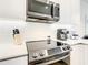 Modern kitchen featuring stainless steel appliances, white cabinets, and sleek countertops at 17230 Blessing Dr, Clermont, FL 34714