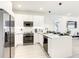 Contemporary kitchen with white cabinets, modern appliances, and sleek countertops at 17230 Blessing Dr, Clermont, FL 34714