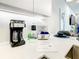 Well-stocked kitchen area with coffee maker, paper towels, and helpful information for guests at 17230 Blessing Dr, Clermont, FL 34714
