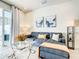 Well-decorated living room features a plush sofa, stylish lighting, and sliding glass door at 17230 Blessing Dr, Clermont, FL 34714
