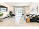 Bright living room with a comfortable sofa, TV, and sliding doors to the patio at 17230 Blessing Dr, Clermont, FL 34714