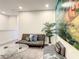 Inviting living room with comfortable gray sofa, glass coffee table and plant at 17230 Blessing Dr, Clermont, FL 34714