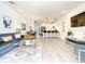 Spacious living area with open layout to the dining and kitchen, offering a modern design at 17230 Blessing Dr, Clermont, FL 34714