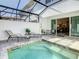 Outdoor pool and patio area with sliding door access to indoor seating and entertainment at 17230 Blessing Dr, Clermont, FL 34714