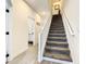 Bright staircase featuring white railings, carpeted steps and natural light at 17230 Blessing Dr, Clermont, FL 34714