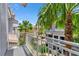 Balcony view showcases lush palm trees, landscaping, and the exterior of the surrounding buildings at 1767 Piedmont Pl, Lake Mary, FL 32746