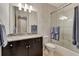 Bathroom featuring single sink vanity, enclosed shower and grey patterned wallpaper at 1767 Piedmont Pl, Lake Mary, FL 32746