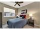Bedroom with neutral walls, ceiling fan, blue quilt, and two side tables at 1767 Piedmont Pl, Lake Mary, FL 32746