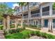 The exterior elevation features a green garden space, sidewalk, and grey building with white balconies at 1767 Piedmont Pl, Lake Mary, FL 32746