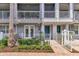 Charming exterior of a light gray townhome with a white picket fence and a vibrant teal door at 1767 Piedmont Pl, Lake Mary, FL 32746