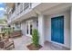 Charming exterior of a light gray townhome with a white fence and vibrant blue door at 1767 Piedmont Pl, Lake Mary, FL 32746