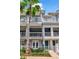 Multi-story townhome featuring balconies, well-manicured landscaping, and a welcoming entrance at 1767 Piedmont Pl, Lake Mary, FL 32746