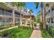 The exterior elevation features a green garden space, sidewalk, grey buildings, and tropical landscaping at 1767 Piedmont Pl, Lake Mary, FL 32746